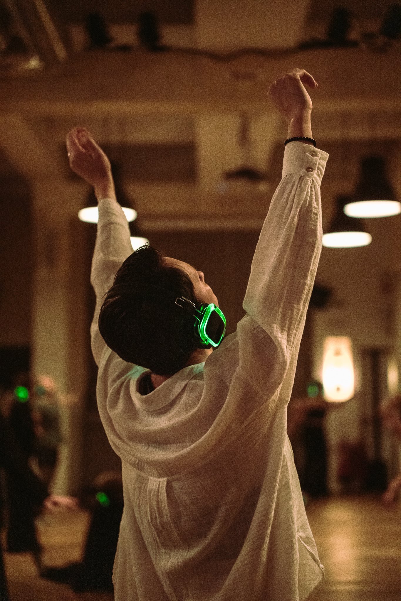A dancer mid-motion, arms raised, in ecstatic movement