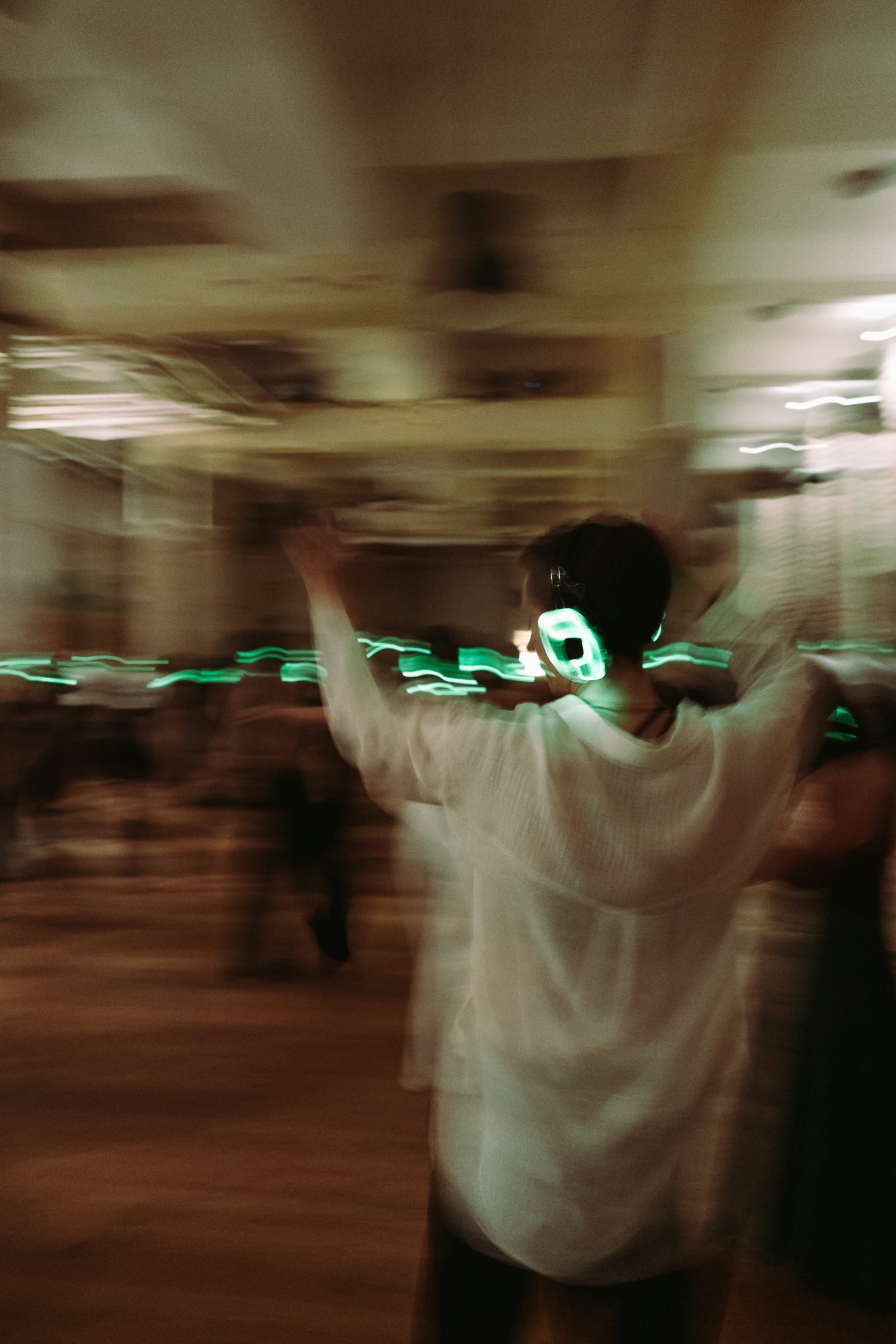 A dancer mid-motion, arms raised, ecstatic movement and light