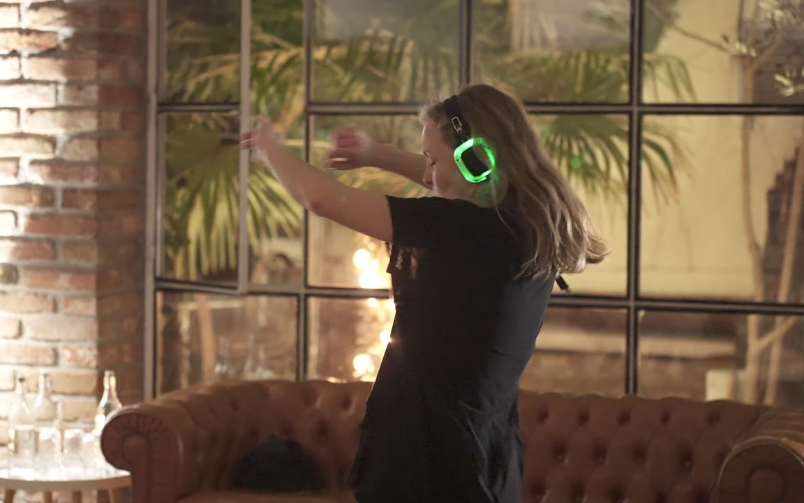 Moments from a Soul Rave session, dancers with glowing headphones moving between stillness and motion